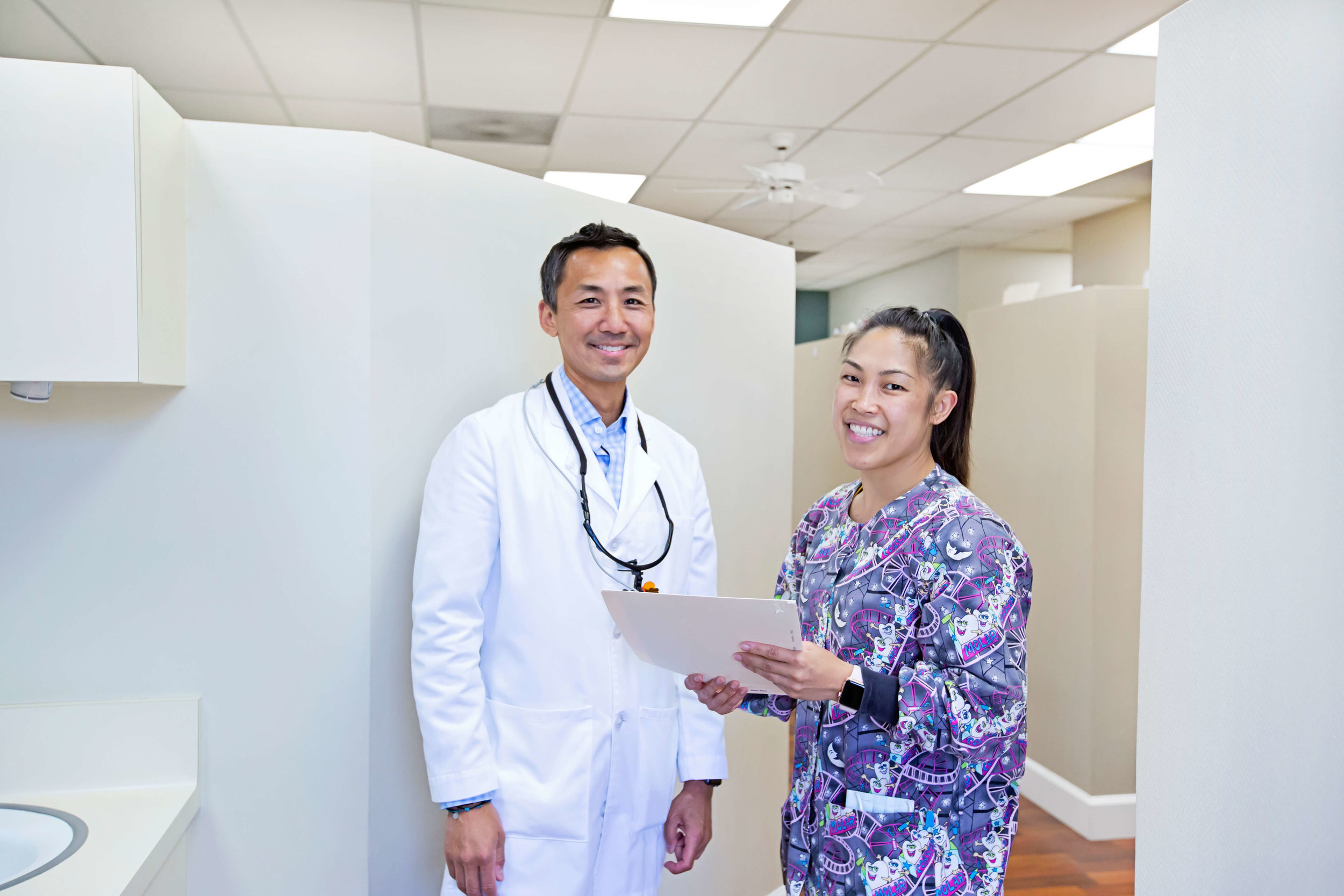 Dr. Leon Chang standing with a dental team member in the office
